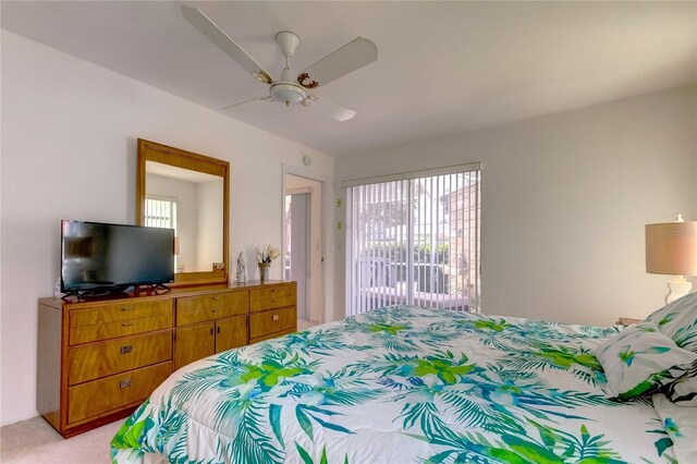 bedroom with ceiling fan and light carpet