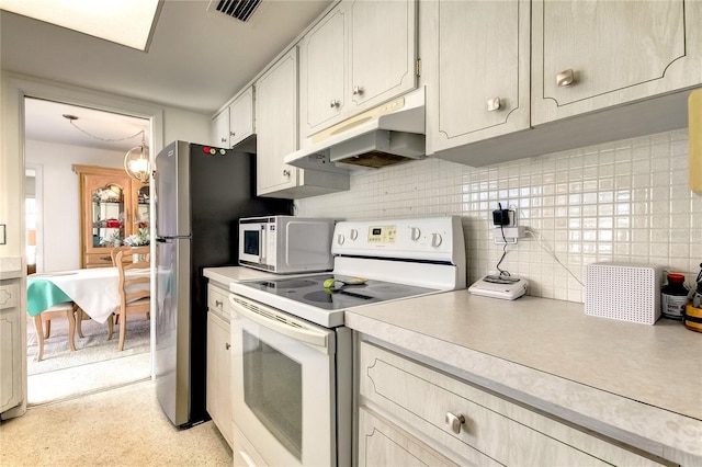 kitchen with backsplash, white appliances, and a notable chandelier