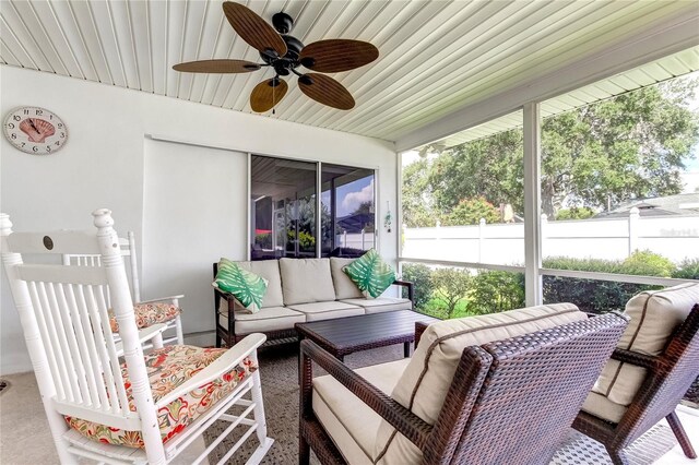 sunroom featuring ceiling fan and wooden ceiling