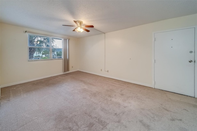 carpeted empty room with a textured ceiling and ceiling fan