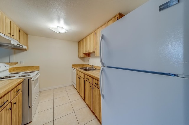 kitchen featuring a textured ceiling, sink, white appliances, light tile patterned floors, and light brown cabinetry