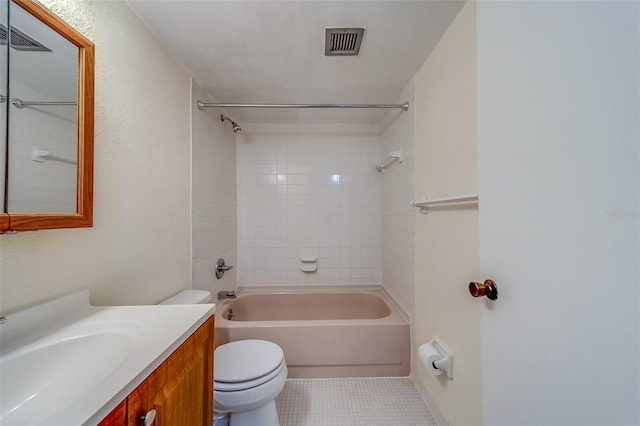 full bathroom featuring tile patterned floors, tiled shower / bath combo, vanity, and toilet