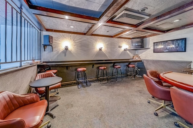 rec room featuring coffered ceiling, carpet floors, beam ceiling, and indoor bar