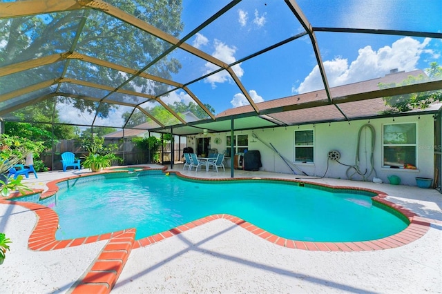 view of swimming pool featuring a lanai and a patio