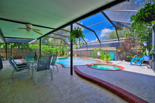 view of patio with glass enclosure, a pool with hot tub, and ceiling fan