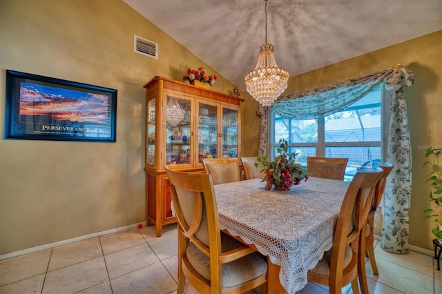 dining room featuring lofted ceiling, light tile patterned floors, a textured ceiling, and an inviting chandelier