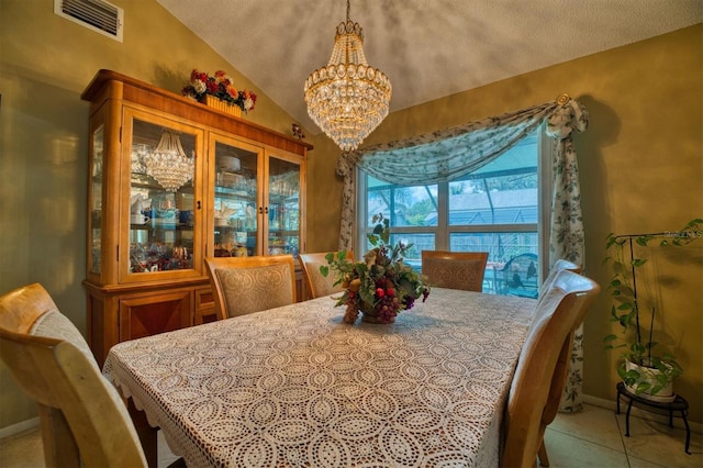 tiled dining space with lofted ceiling, a chandelier, and a textured ceiling