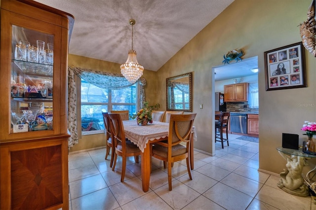 tiled dining room featuring a textured ceiling, vaulted ceiling, and a notable chandelier