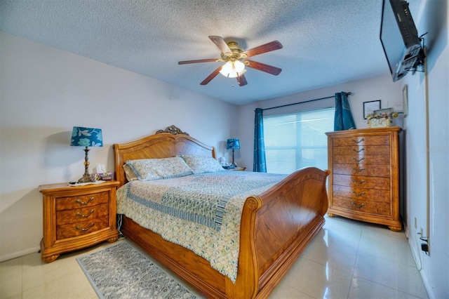 bedroom featuring ceiling fan and a textured ceiling