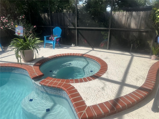 2011 Green Juniper Ln, Brandon, FL 33511 - view of pool with an in-ground hot tub, a patio, and glass enclosure