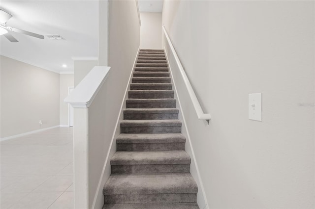 stairs with ornamental molding, ceiling fan, and tile patterned floors