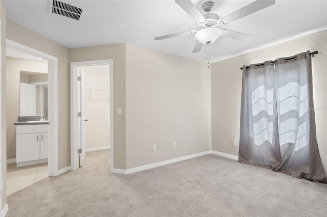 empty room featuring ceiling fan, light carpet, and sink