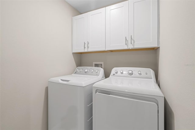 laundry area featuring cabinets and washing machine and clothes dryer