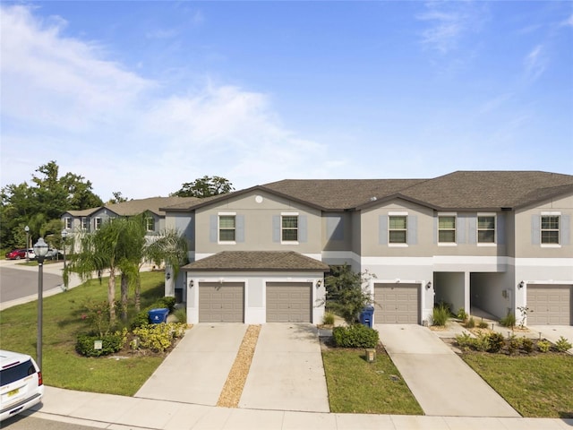 view of front of property featuring a garage and a front lawn