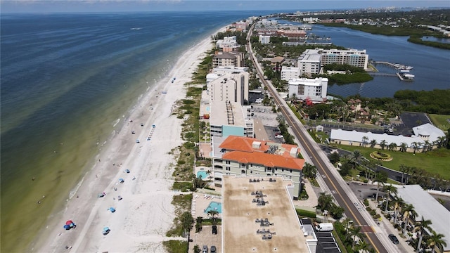 bird's eye view featuring a water view and a beach view