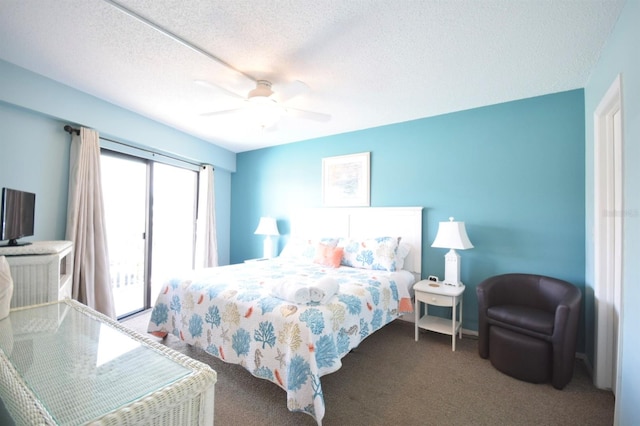 carpeted bedroom featuring ceiling fan and a textured ceiling