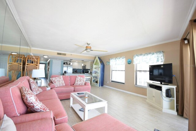 living room featuring light hardwood / wood-style flooring, ceiling fan, and ornamental molding