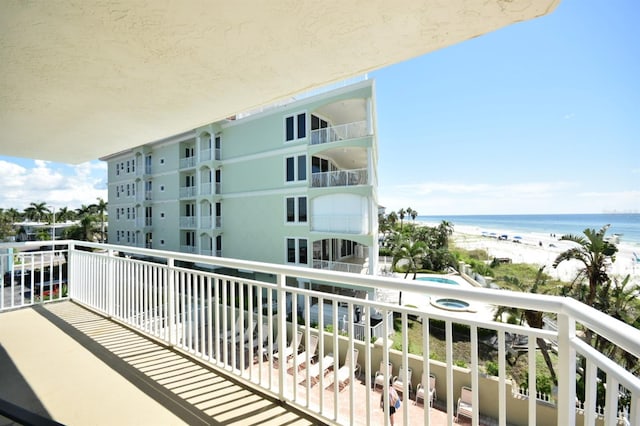 balcony with a water view and a beach view