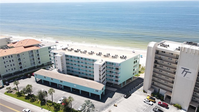 birds eye view of property with a view of the beach and a water view