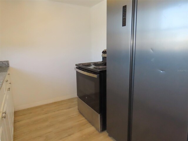 kitchen featuring light hardwood / wood-style floors, white cabinetry, and stainless steel appliances