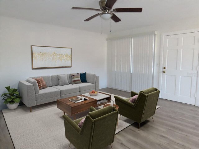 living room featuring ceiling fan and light hardwood / wood-style flooring