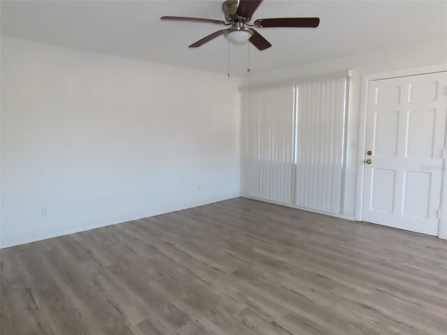 spare room featuring hardwood / wood-style flooring and ceiling fan