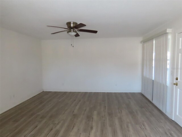 unfurnished room featuring dark hardwood / wood-style floors and ceiling fan