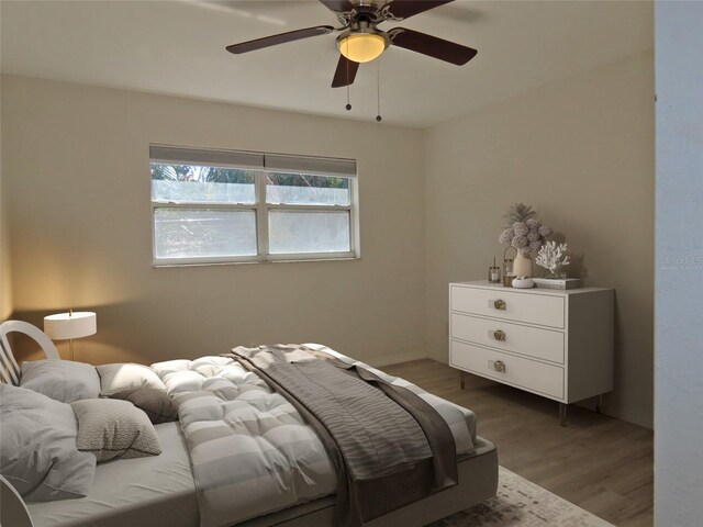 bedroom with hardwood / wood-style flooring and ceiling fan