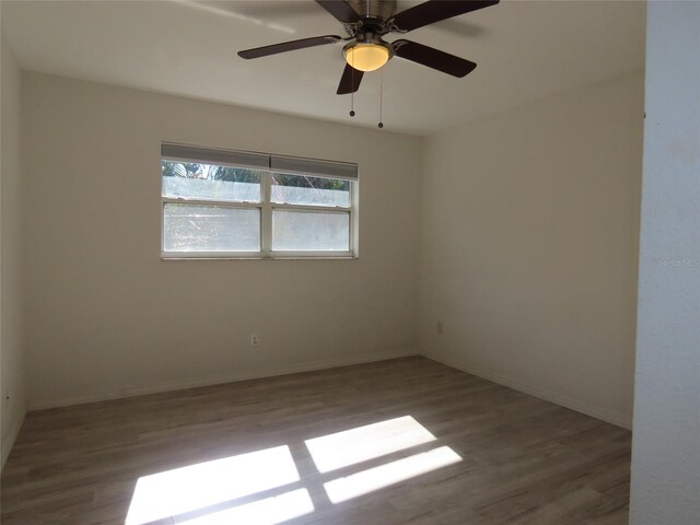 empty room with ceiling fan and hardwood / wood-style flooring