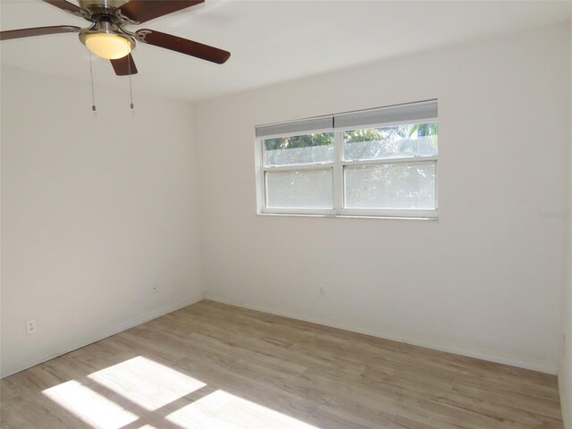 empty room with ceiling fan and light wood-type flooring