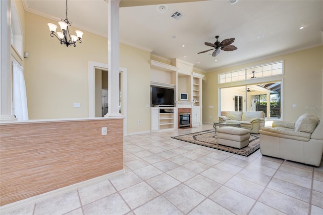 living room with ceiling fan with notable chandelier, built in shelves, ornamental molding, light tile patterned flooring, and decorative columns