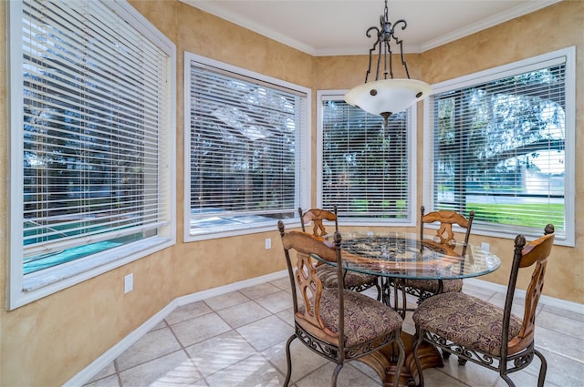 dining space featuring light tile patterned floors, a wealth of natural light, and crown molding