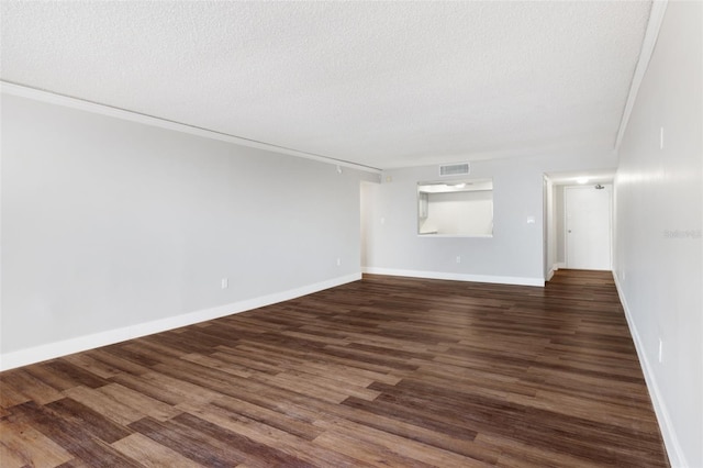 unfurnished room featuring ornamental molding, a textured ceiling, and dark wood-type flooring