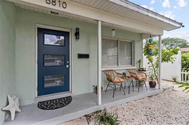 view of exterior entry with covered porch