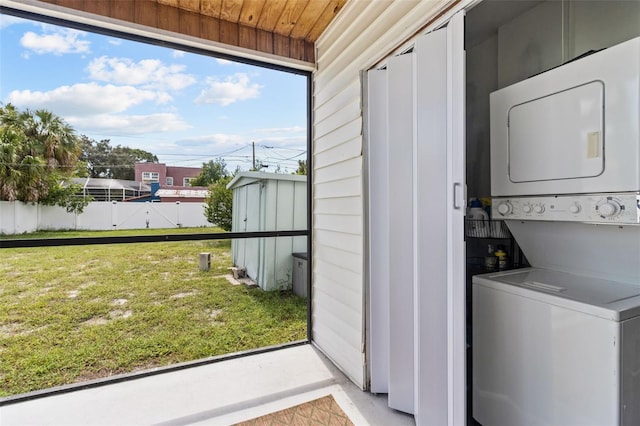 washroom with stacked washer and clothes dryer