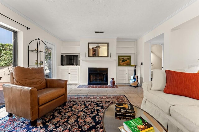 tiled living room featuring ornamental molding and a textured ceiling