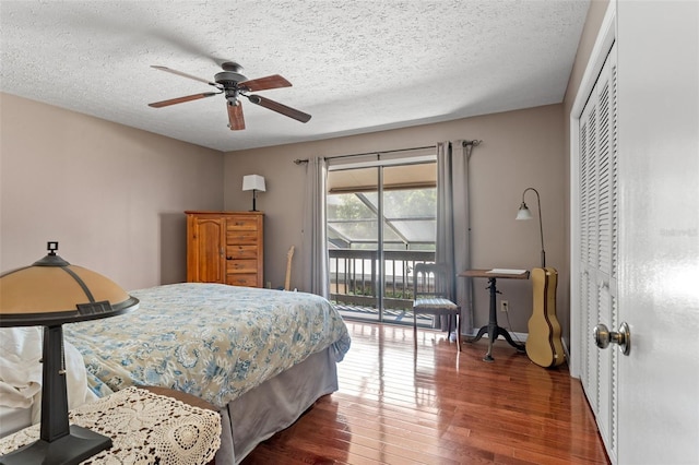 bedroom featuring dark hardwood / wood-style flooring, access to exterior, ceiling fan, a textured ceiling, and a closet