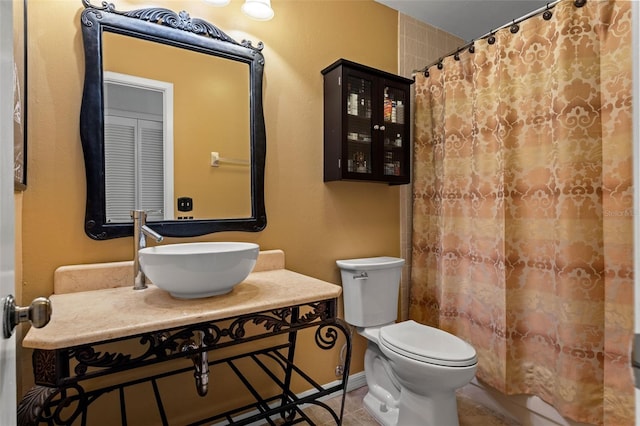 bathroom with tile patterned flooring, sink, a shower with curtain, and toilet