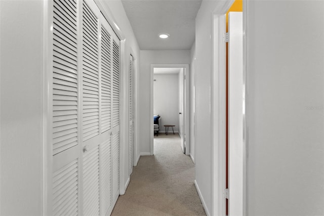 corridor with light colored carpet