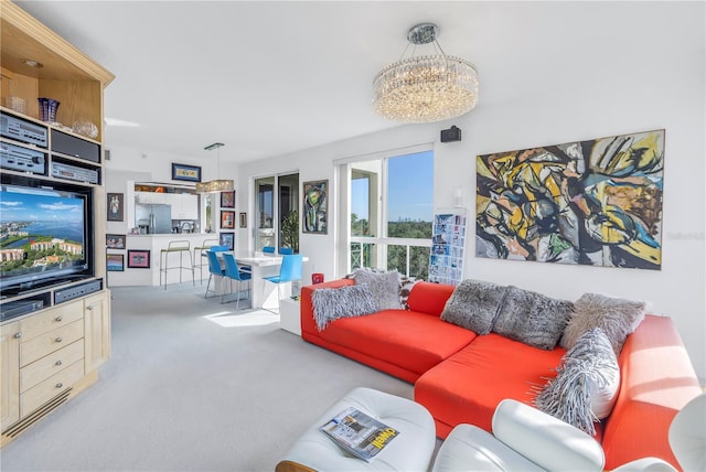 carpeted living room with a chandelier