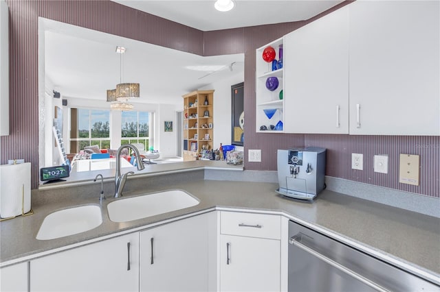 kitchen with sink, white cabinetry, dishwasher, and decorative light fixtures