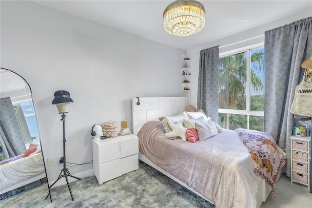 bedroom with a notable chandelier and carpet