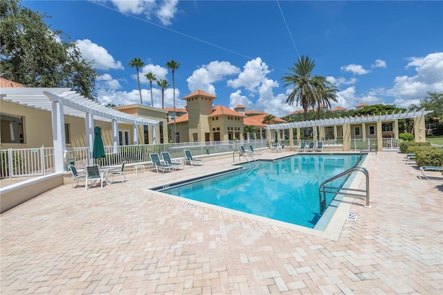 view of swimming pool featuring a patio area and a pergola