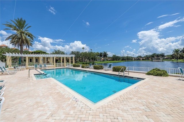 view of swimming pool featuring a pergola, a water view, and a patio area