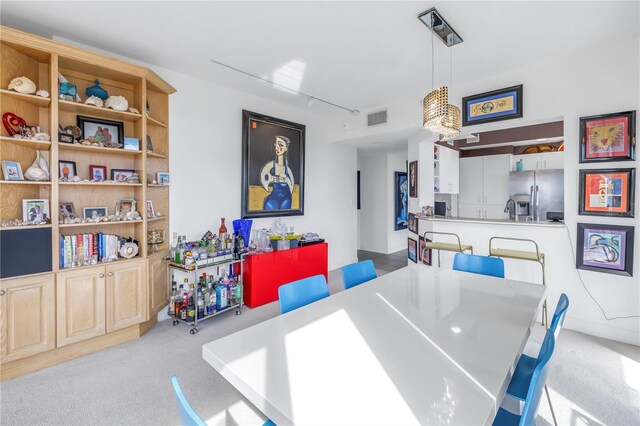 carpeted dining space featuring sink