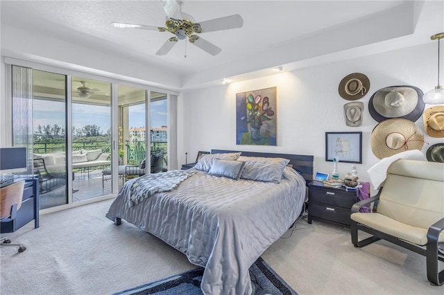 carpeted bedroom featuring ceiling fan and access to exterior