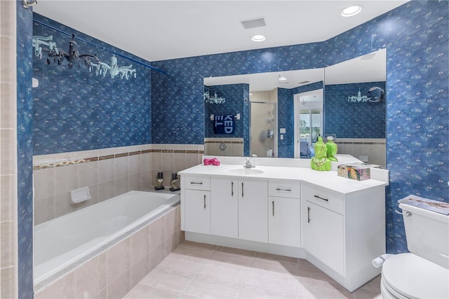 full bathroom with toilet, separate shower and tub, tile patterned floors, and vanity