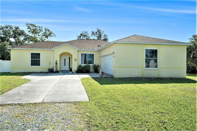 ranch-style house featuring a garage and a front lawn