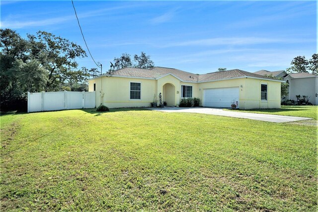 single story home featuring a garage and a front lawn