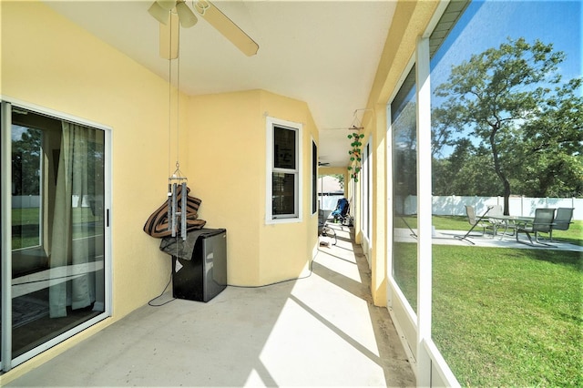 sunroom / solarium featuring ceiling fan